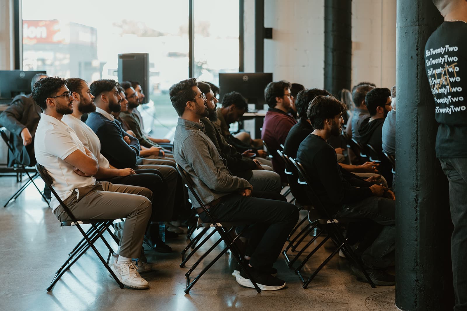 The cohort seated in rows during a session.