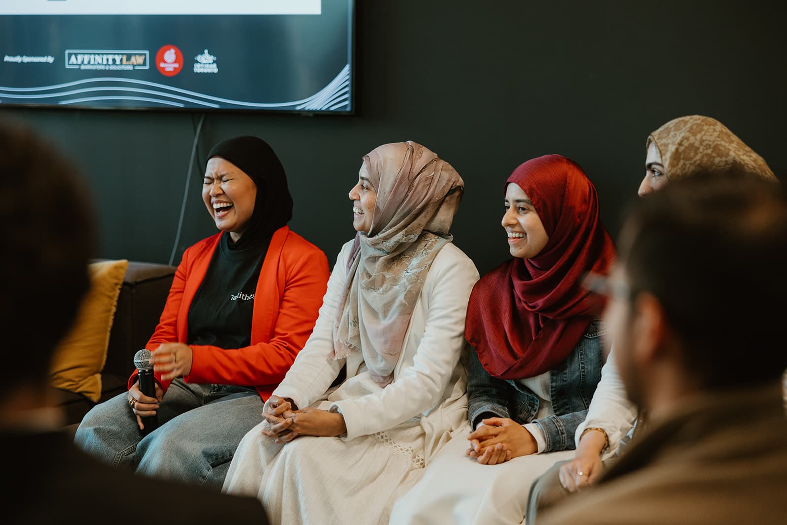 Founders laughing together on the couch during a session.